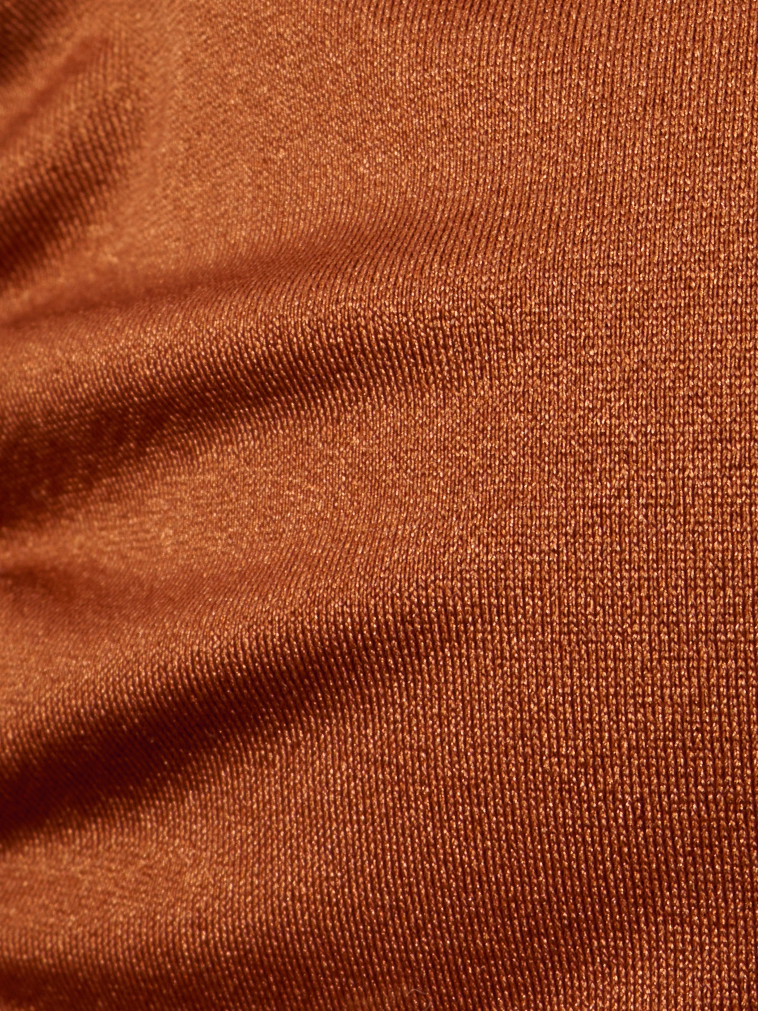 Close-up of brown, textured fabric with visible weave pattern and slight wrinkles on the Annabelle Triangle Bikini Top, creating a sense of depth and softness—perfect for an adjustable fit or luxe hardware details.