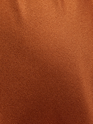 Close-up of the Sirena Halter Bikini Top features a textured, rust-colored fabric with a soft, even weave and gentle folds, highlighted by a subtle bronze shimmer.