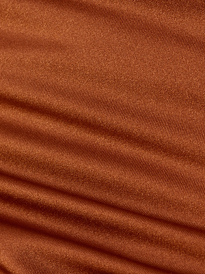 Close-up of the Britt Tie-Side Bikini Bottom in rust-colored fabric with visible horizontal lines and subtle folds, showcasing a soft, slightly shiny surface—ideal for moderate coverage in a bronze bikini style.