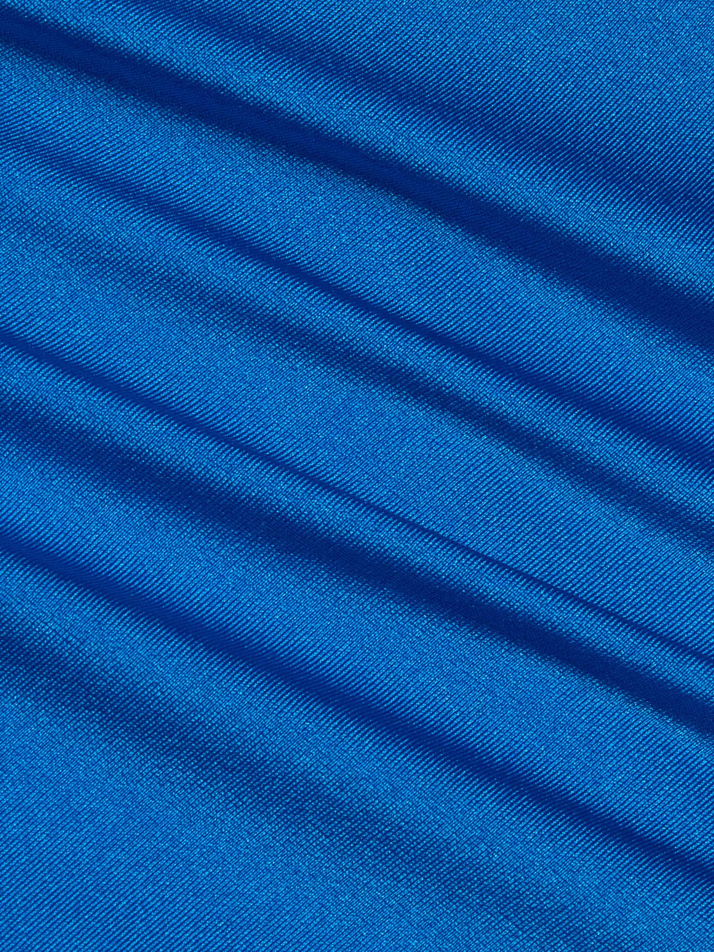 Close-up of the Britt Tie-Side Bikini Bottom in capri blue, showcasing its smooth, shiny fabric with diagonal soft folds. The light catches the ridges, creating a shimmering effect across the material.