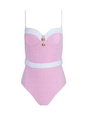 The Amie Bandeau One-Piece Swimsuit features a pink bouclé nylon design with white straps, white trim at the bust and waist, two gold decorative buttons on the chest, and a subtle textured pattern.