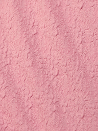 Close-up of the Jean Bikini Bottom’s textured pink bouclé fabric, featuring a soft, uneven surface with raised patterns—perfect for a chic high-leg cut and on-trend poolside style.