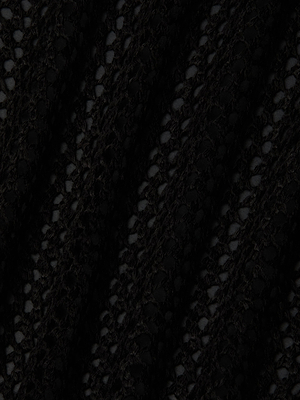 Close-up of the Pallas Crochet Cover-Up Dress in black, featuring an open-knit, lacy pattern with diagonal folds for a striped effect—perfect for romantic beachwear or as a stylish tropical crochet midi dress.