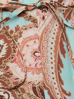 Close-up of the Geraldine Cover-Up Pant in a paisley print with brown, pink, and cream on light blue, featuring a tied string detail—ideal for effortless resort wear.