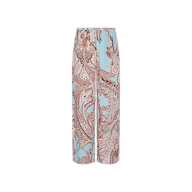 The Geraldine Cover-Up Pant showcases a relaxed wide-leg silhouette with an intricate brown paisley print on a light blue background, displayed against a plain white backdrop—perfect for resort wear.