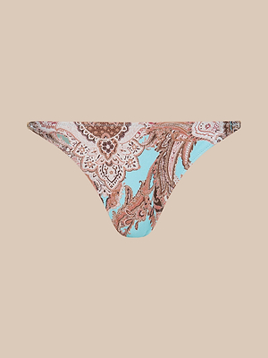 The Violet String Bikini Bottom features a blue paisley print with brown, beige, and pink accents, shown against a plain beige backdrop.