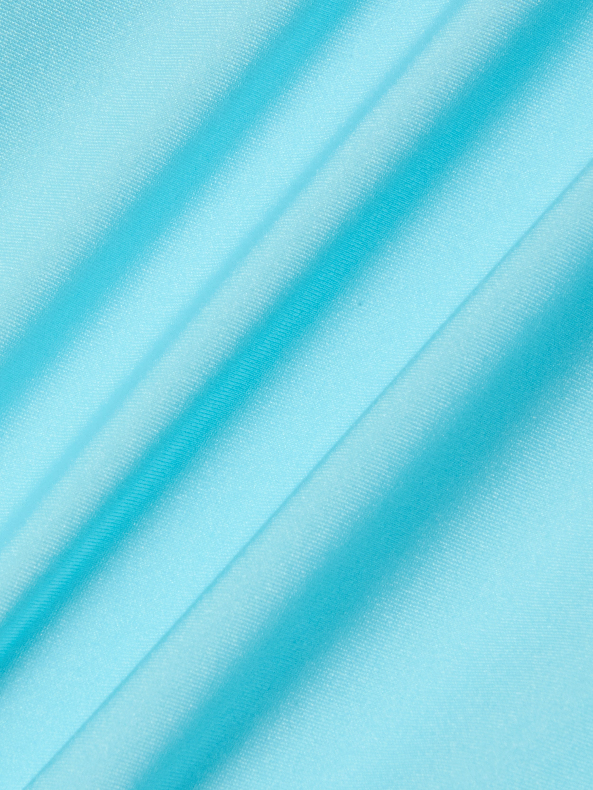 Close-up of the Remi One-Piece Swimsuit in ice blue, featuring smooth fabric with soft diagonal folds and a shiny, slightly reflective texture.