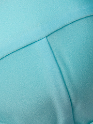 Close-up of light blue fabric with visible stitching and seams, featuring a smooth, slightly shiny texture—ideal for the Alexandria Bikini Top, expertly crafted from UPF 50 swimwear material.