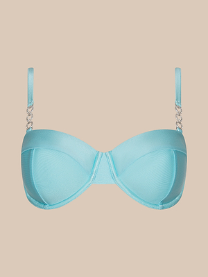 The Alexandria Bikini Top is a light blue balconette with underwire, thin adjustable straps, and silver chain accents by the straps, shown on a beige background—a chic update to the classic ice blue bikini.