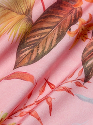 The Remi One-Piece Swimsuit features pink fabric adorned with a detailed tropical floral and palm leaf print in brown, orange, and yellow hues. The softly crinkled material enhances the texture and vibrant botanical pattern—ideal for crafting an eye-catching one-piece or high-leg swimsuit.