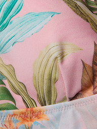 Close-up of the Lexie Bikini Top in pink fabric, showcasing a vibrant palm leaf print and detailed edge stitching.