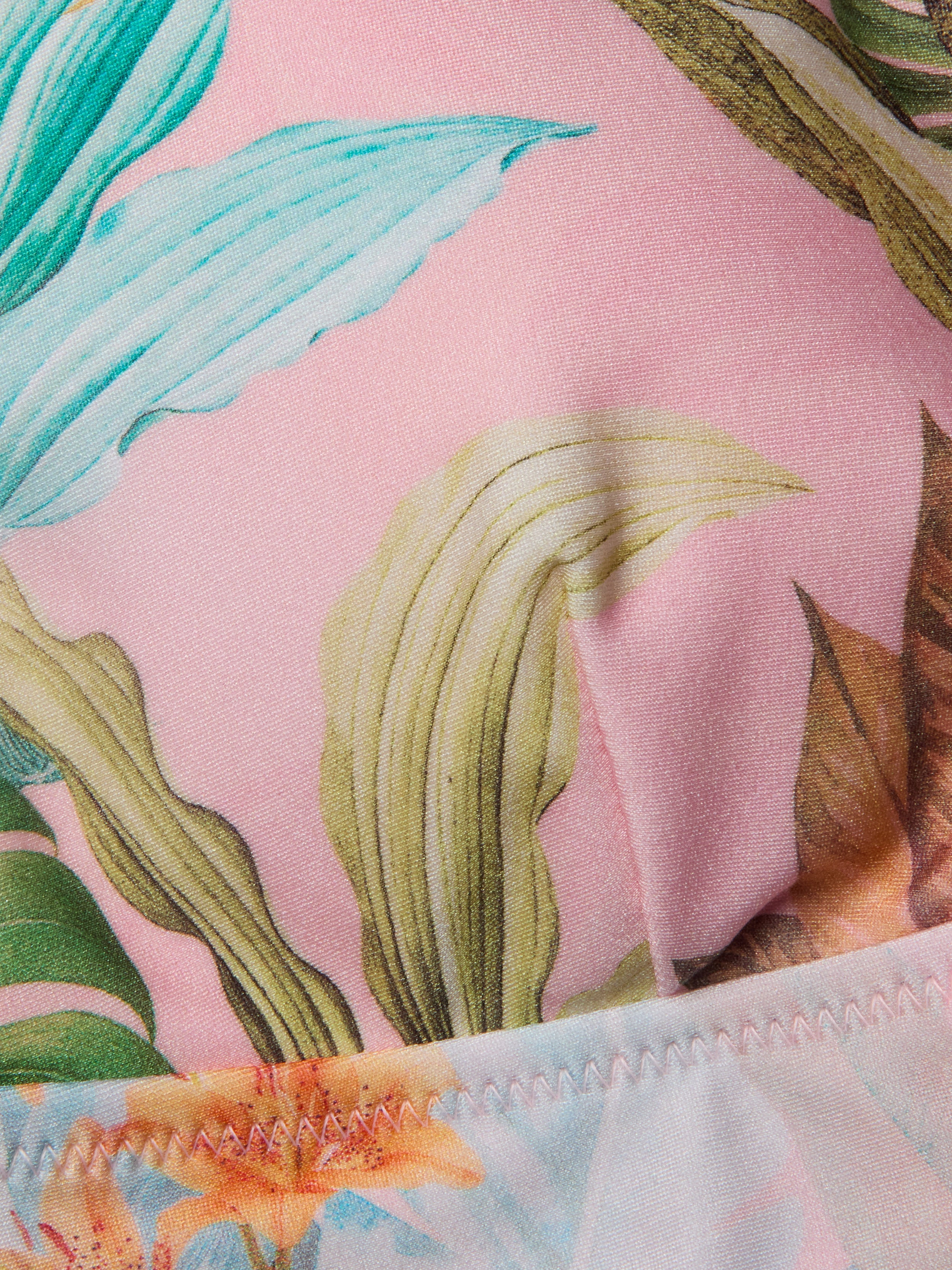 Close-up of the Lexie Bikini Top in pink fabric, showcasing a vibrant palm leaf print and detailed edge stitching.