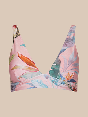 The Lexie Bikini Top features a deep V neckline, adjustable straps, and a bold palm leaf print in green, orange, and blue on pink, shown against a plain beige background.