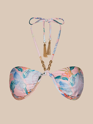 The Suki Halter Bikini Top features pink, blue, and green floral palm leaf patterns, halter neck straps with gold beads and chain tassels. Displayed on a beige background, this chic top offers both style and UPF 50 swimwear protection.