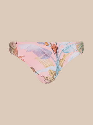 The Nicole Bikini Bottom features a pink base with vibrant palm leaf and colorful flower prints, made from stretch nylon for comfort and UPF 50 sun protection. Shown on a plain beige background.