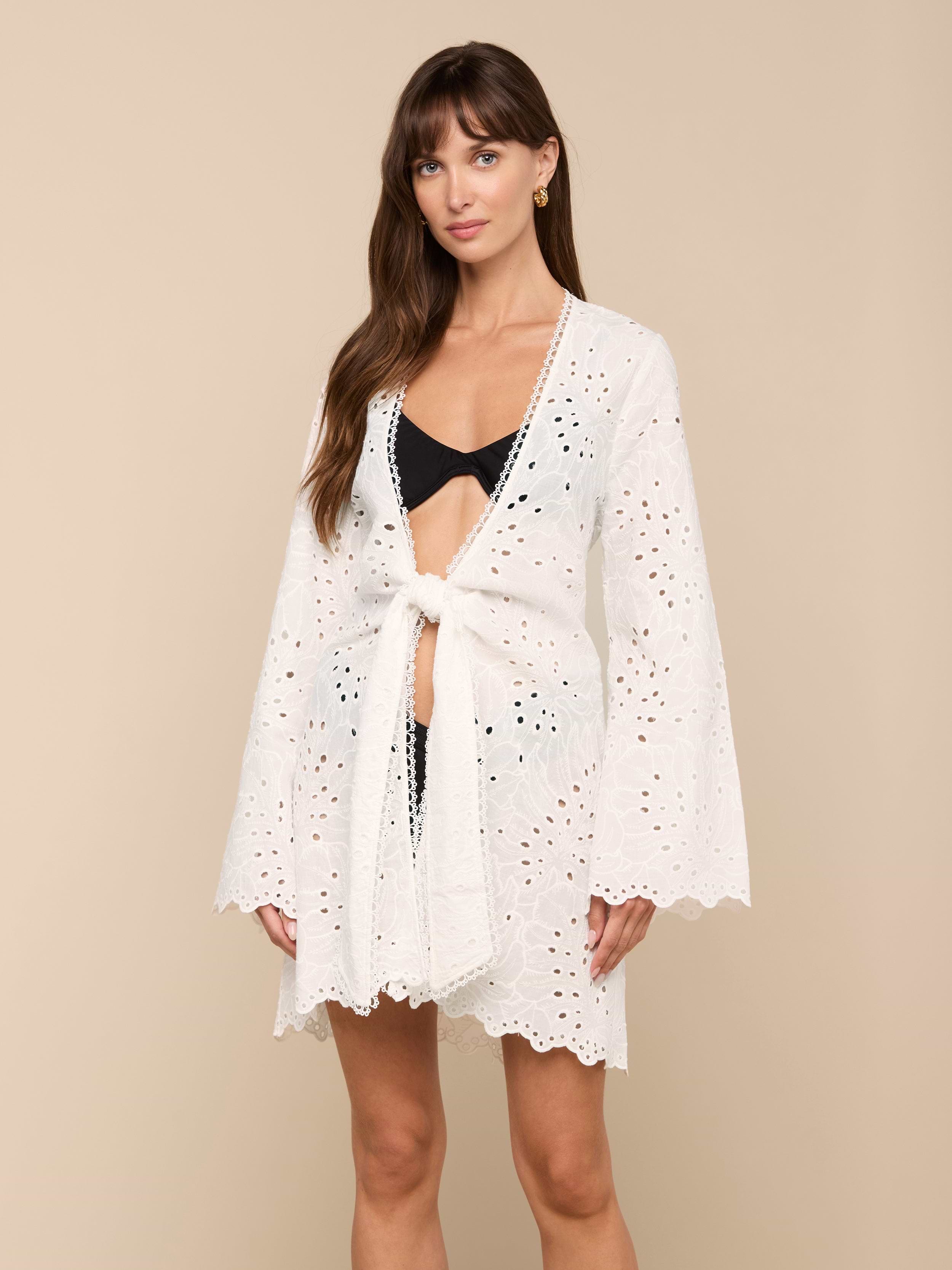 Woman wearing the Navaeh Cover-Up Kimono tied at the waist over a black bikini, standing against a plain light background.