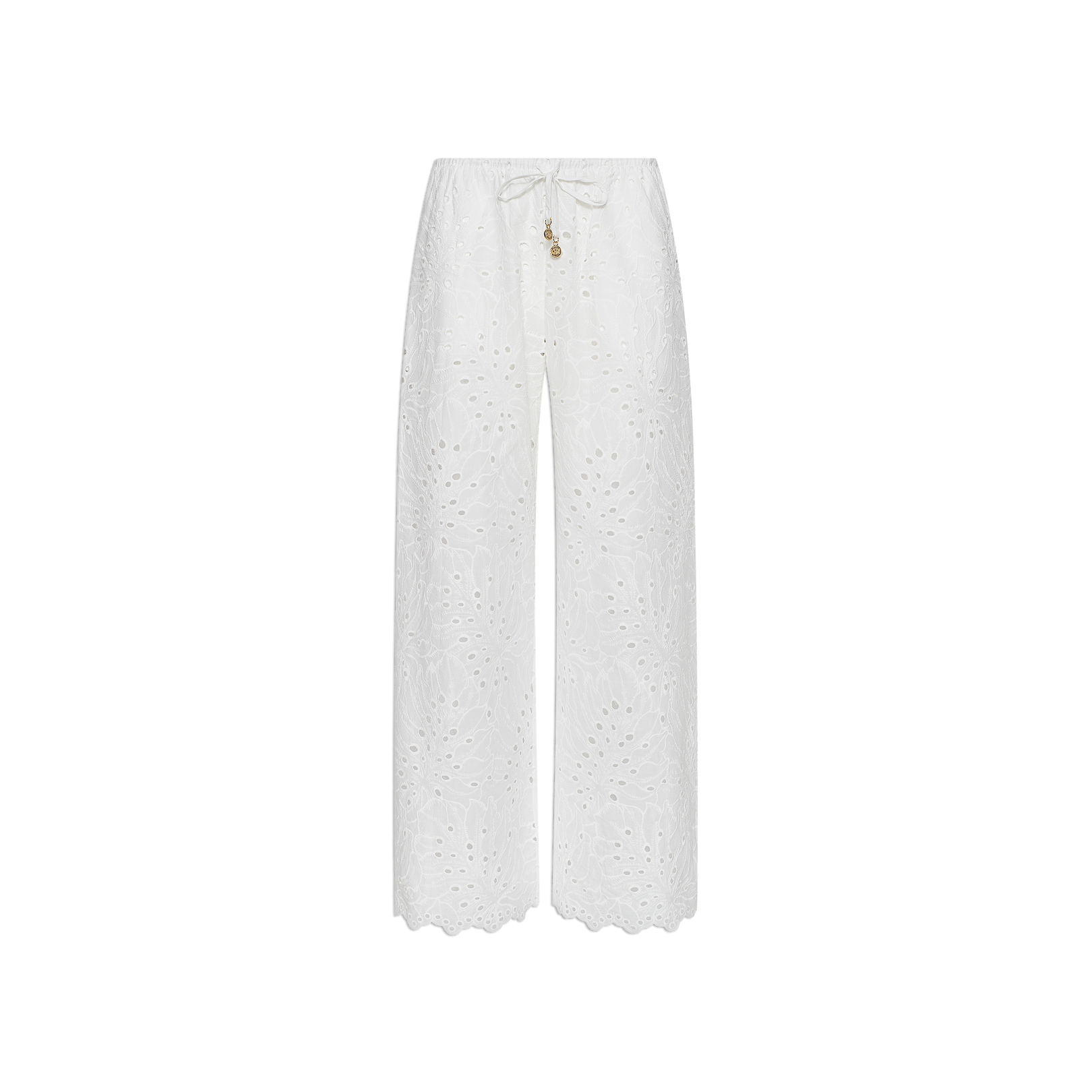 The Geraldine Eyelet Cover-Up Pant features a white, wide-leg silhouette crafted from cotton eyelet, complete with scalloped hems and a tie waist accented by small decorative charms—making it perfect for resort wear. Shown against a plain white background.