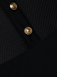 A close-up of the Natalya Collared One-Piece Swimsuit in black showcases its textured fabric with two gold decorative buttons, featuring a mesh-like hexagonal pattern reminiscent of a mesh one piece and smooth black panels intersecting diagonally across the image.
