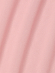 A close-up of the Mahe Mesh Cover-Up Skirt in light pink, featuring soft diagonal folds that create gentle shadows and highlight its smooth, poolside-inspired mesh texture.