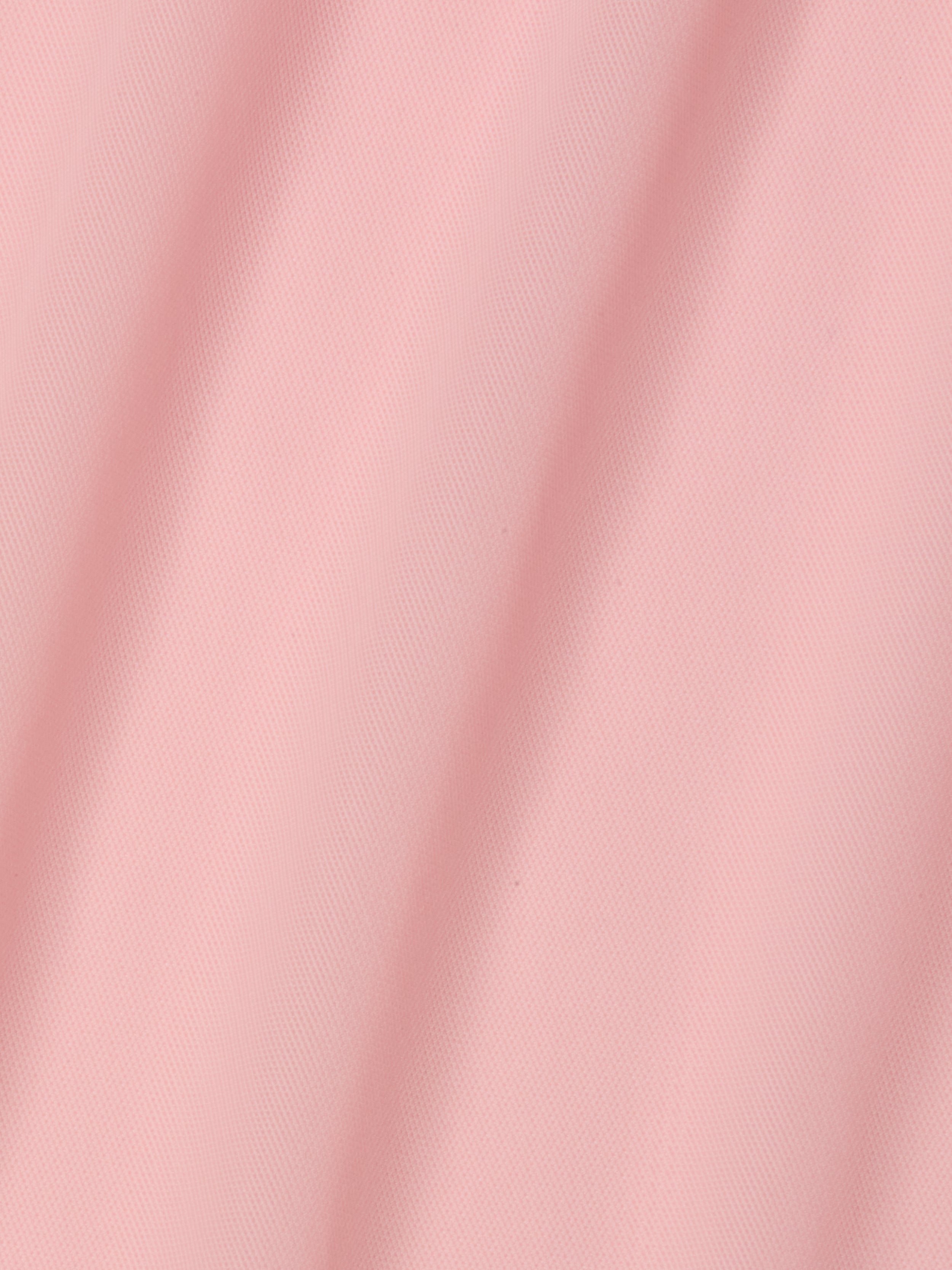 A close-up of the Mahe Mesh Cover-Up Skirt in light pink, featuring soft diagonal folds that create gentle shadows and highlight its smooth, poolside-inspired mesh texture.