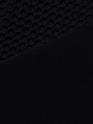 Close-up of the Anastasia Swim Top—a black polo-style top with a textured, honeycomb pattern on the upper half and a sleek, solid black finish on the lower half—perfect for showcasing beachside sophistication.