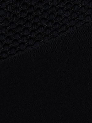 Close-up of the Anastasia Swim Top in black with a textured honeycomb upper section and a smooth, solid lower section, separated by a diagonal line.
