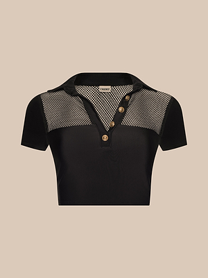 The Anastasia Swim Top is a black cropped polo with short sleeves, a collared neckline, mesh panels on the shoulders and chest, and three gold buttons on the front placket, shown against a beige background.