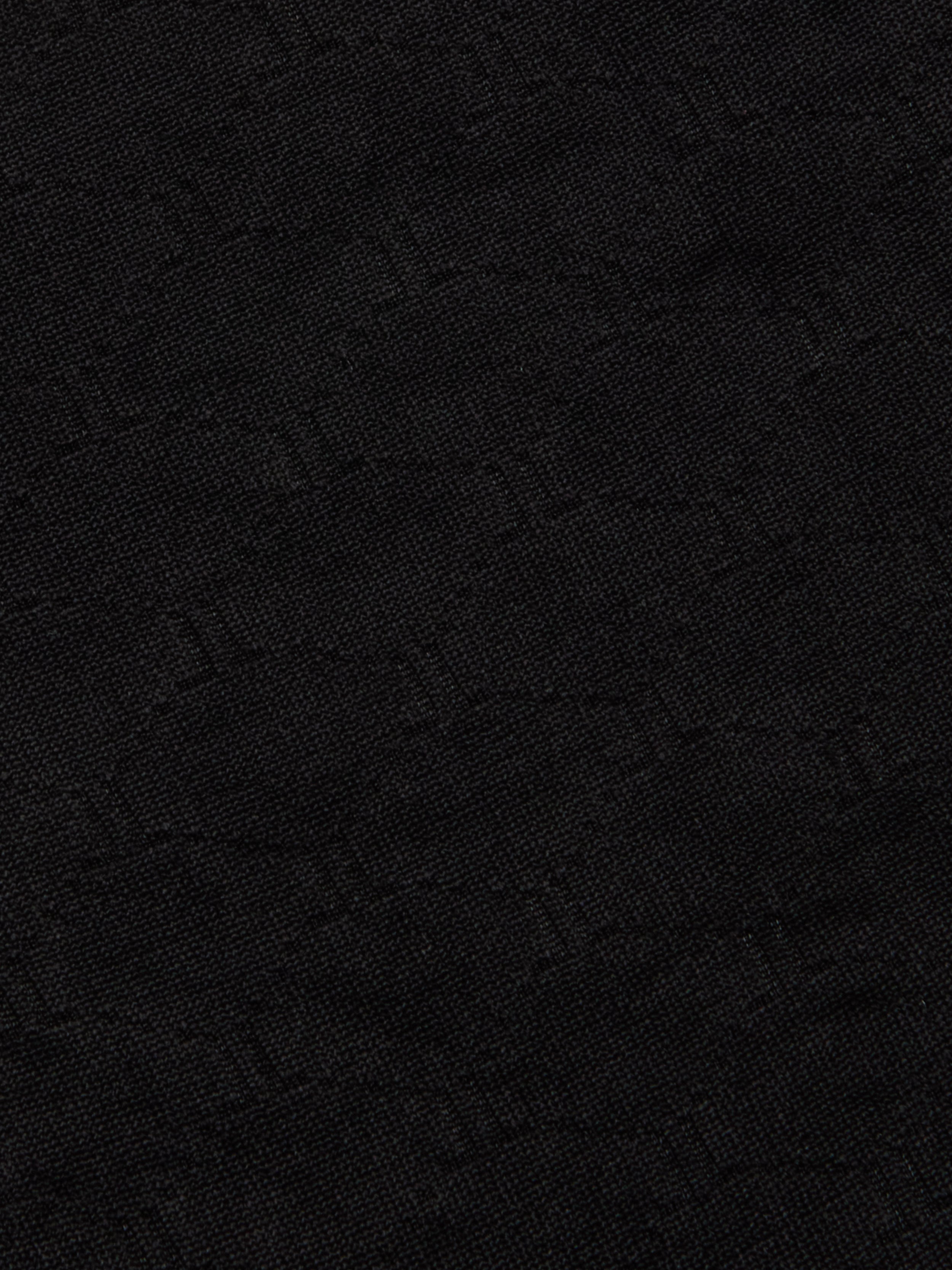 Close-up of the Annabelle Bikini Top crafted from dark black fabric with a subtle, woven geometric pattern and a slightly textured surface—perfect for UPF 50 swimwear or a chic black triangle bikini with an adjustable fit.