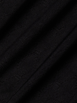 A close-up of black textured fabric with subtle diagonal folds and a faint woven pattern, ideal for crafting the Violet String Bikini Bottom with UPF 50 protection.