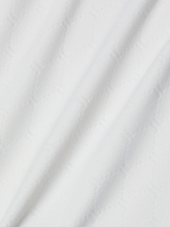 A close-up of white textured fabric with a subtle geometric hexagon pattern and soft diagonal folds, similar to the material used in the Violet String Bikini Bottom, which offers moderate coverage and UPF 50 protection.