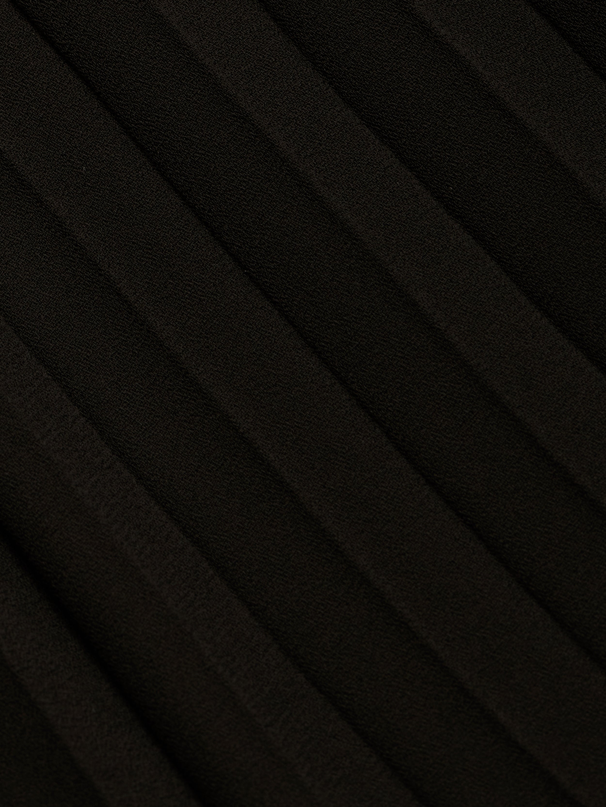 Close-up of the Adalynn Cover-Up Dress in black, featuring textured fabric with diagonal, evenly spaced ridges that create a pleated pattern across the surface—reminiscent of the delicate detail often found in a black lace dress.