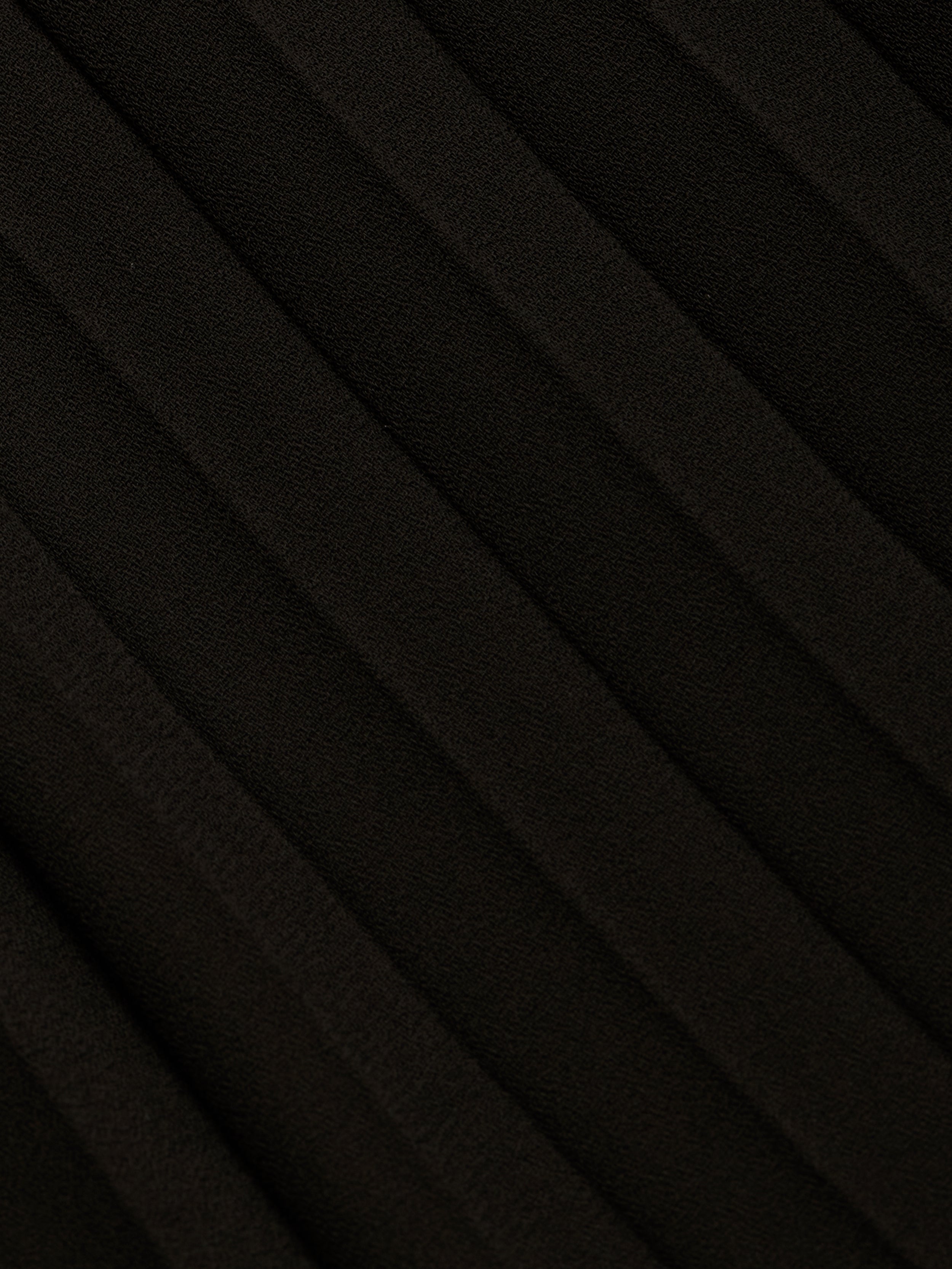 Close-up of the Adalynn Cover-Up Dress in black, featuring textured fabric with diagonal, evenly spaced ridges that create a pleated pattern across the surface—reminiscent of the delicate detail often found in a black lace dress.