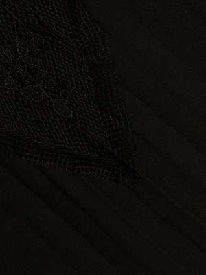Close-up of the Sharon Cover-Up Pant in black, featuring a triangular section of sheer lace and mesh detail for subtle contrast in texture.