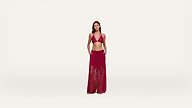 Woman standing against a plain white background, wearing a red halter bikini top and matching sheer, wide-leg beach pants with her hands in her pockets.