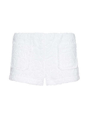 The Amiya Cover-Up Short is a white, high-waisted terrycloth short with a subtle floral texture, two front patch pockets, and a straight hem—ideal for effortless resort style.