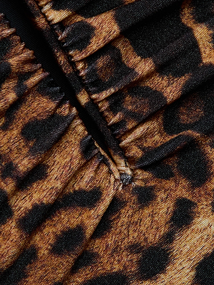 Close-up of the Lilou One-Piece Swimsuit by L'AGENCE, showcasing leopard print fabric with brown and black spots, visible seams, and gathered stitching.