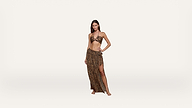 Woman wearing a leopard-print bikini top and matching high-slit sarong skirt, standing barefoot against a plain white background.