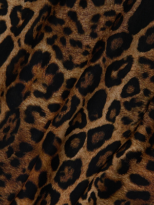 Close-up of the Geraldine Cover-Up Pant’s leopard print fabric, with black spots and rosettes on golden brown. Perfect for stylish wide leg lounge or resort wear, featuring a comfy pull-on fit and softly draping material.