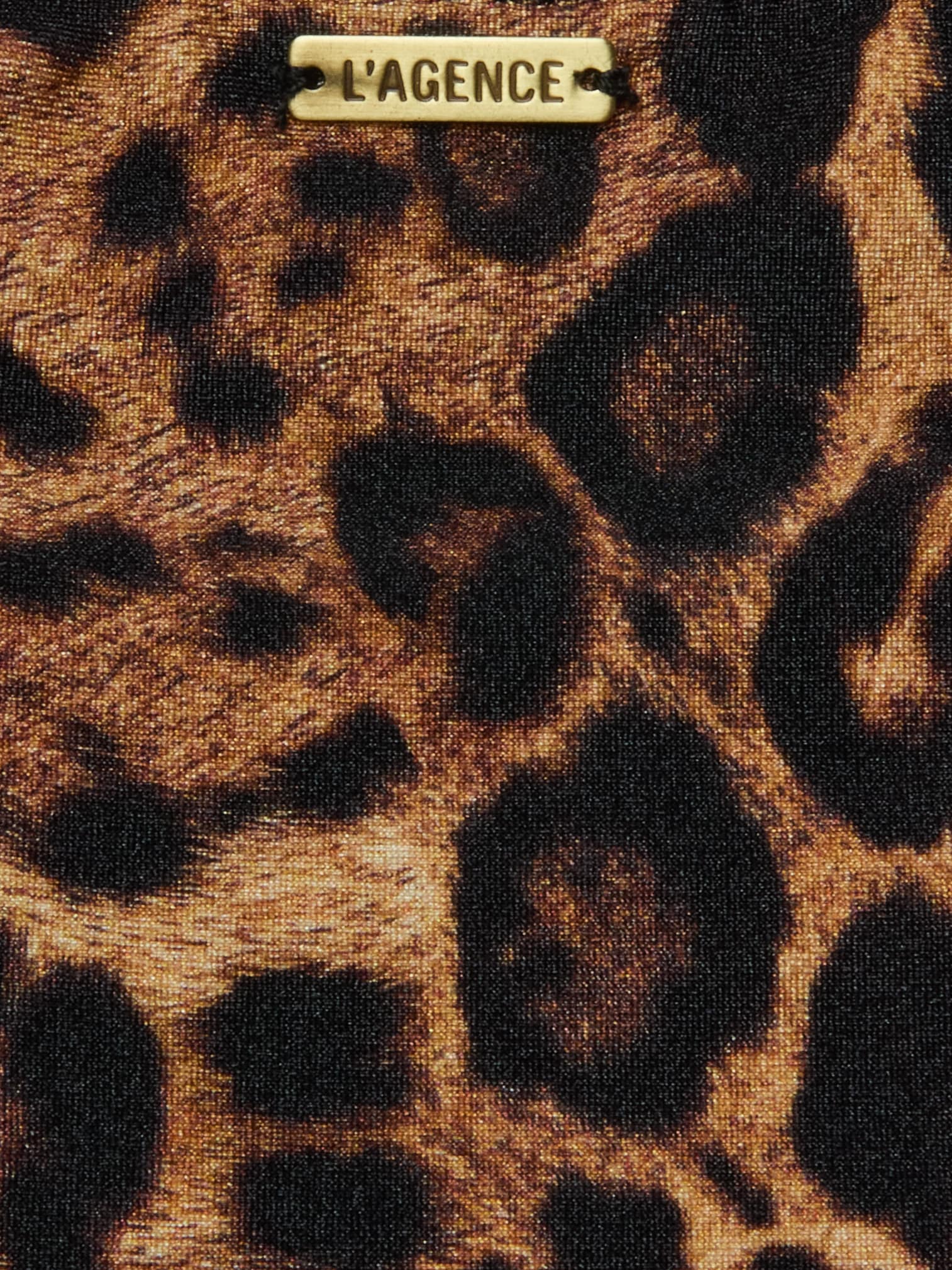 Close-up of the Nicole Bikini Bottom in leopard print, featuring moderate coverage and a small metallic LAGENCE label attached near the top center.
