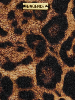 Close-up of the Nicole Bikini Bottom by L’AGENCE, crafted from four-way stretch nylon in a brown and black leopard print, with a small gold metal label engraved with the brand’s name at the top.