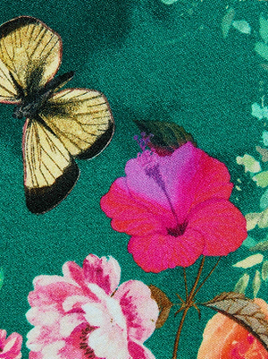 Close-up of the Yazmin Bikini Top, featuring a colorful butterfly floral print with pink and red flowers and a yellow butterfly on a green background—designed with adjustable straps for a perfect fit.