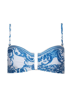 The Krysta Bandeau Top showcases a bold blue baroque print with blue and white swirls, thin adjustable removable straps, and a stylish front metal detail.