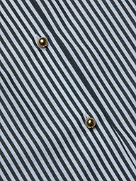 Close-up of the Lorena Cover-Up Shirt, showcasing its cotton poplin fabric with black and white diagonal stripes and two gold buttons sewn in a vertical line. The visible texture and stitching around the buttons highlight the crisp finish reminiscent of a classic resort shirt.