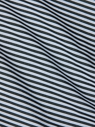 Close-up of fabric with diagonal black and white stripes, featuring a smooth texture and gentle folds—an ideal match for the Amiya Cover-Up Short, perfect for resort dressing.