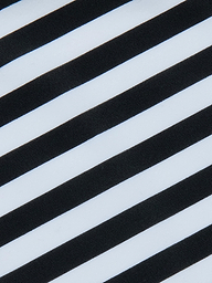 Alternating diagonal black and white stripes create a bold, high-contrast pattern across the Kristin Triangle Bikini Top, evoking the striking visual style of classic French Riviera swimwear.