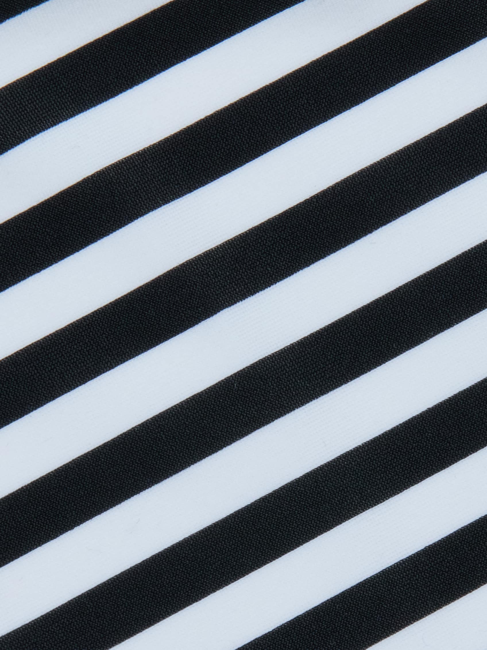 Alternating diagonal black and white stripes create a bold, high-contrast pattern across the Kristin Triangle Bikini Top, evoking the striking visual style of classic French Riviera swimwear.
