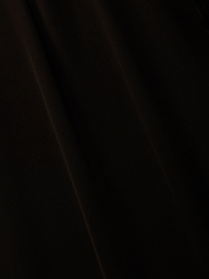 A close-up of black sheer chiffon fabric with subtle folds and soft diagonal shadows, perfect for the elegant Adonis Cover-Up Pant or a chic poolside look.