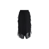 The Adonis Cover-Up Pant features black sheer chiffon fabric with an elastic waistband and layered, asymmetrical ruffle detailing along the sides and hem, making it a stylish choice for effortless poolside style, shown here against a plain white background.