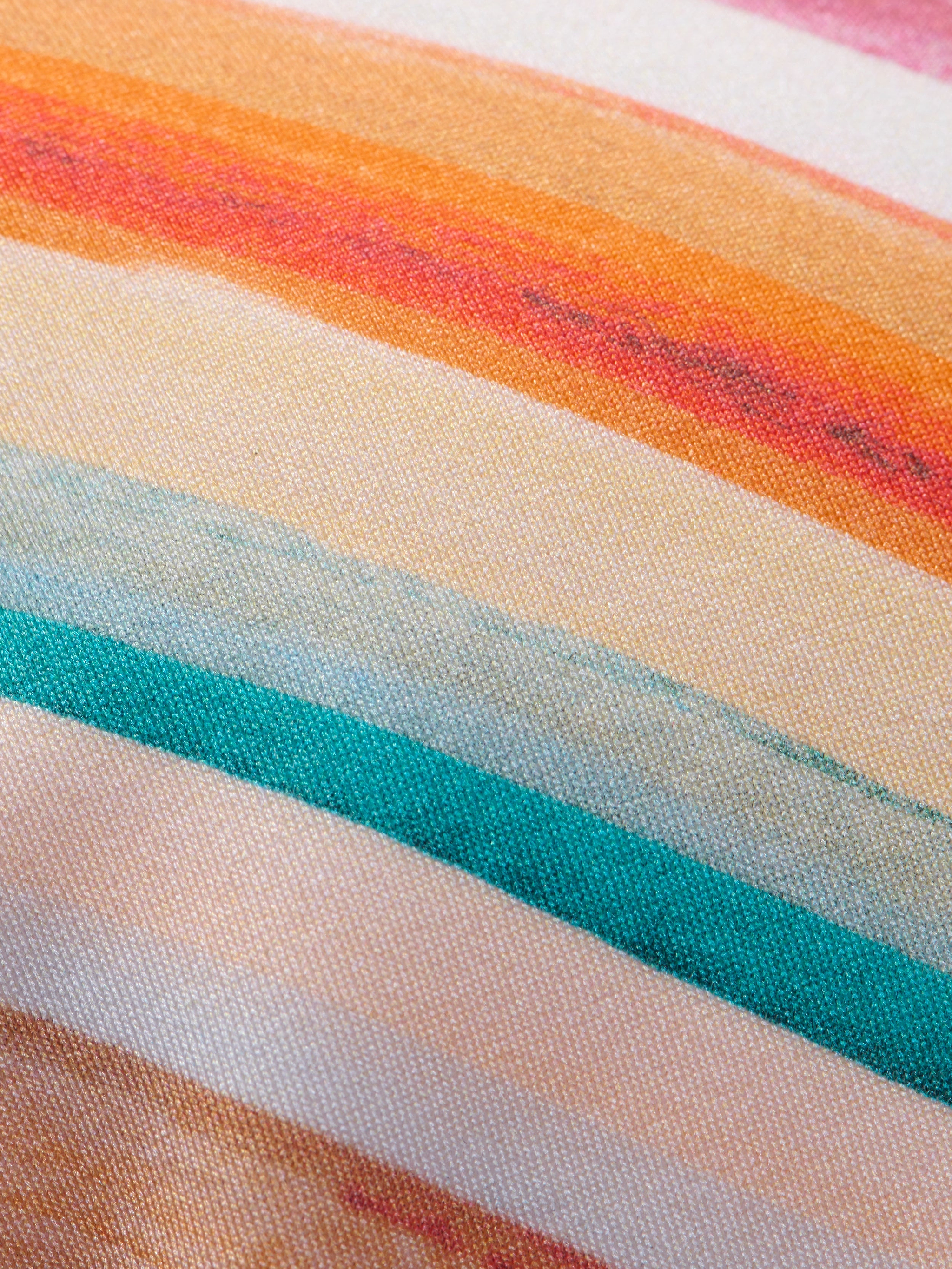 Close-up of the Annabelle Triangle Bikini Top fabric, featuring horizontal, retro-inspired stripes in orange, red, yellow, teal, and light blue tones. The visible texture highlights the weave and vibrant pattern.