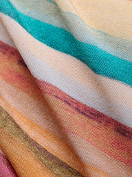 Close-up of the Krysta Halter Bikini Top fabric, featuring wavy, horizontal stripes in teal, orange, yellow, brown, and cream hues. The slightly folded material highlights its textured surface and retro-inspired pattern.